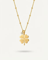 Gold plated four leaf clover pendant with a small crystal, on a beaded stainless steel chain