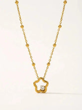 Gold plated open star pendant with a single crystal, on a beaded chain