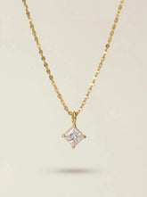 Gold plated necklace with a square cut clear crystal pendant on a shimmering flat chain