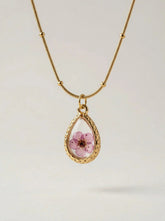 Gold plated teardrop pendant with a real pressed pink flower set in resin, on a snake chain