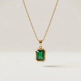 Green Stone Pendant Necklace in gold plated stainless steel on a plain background