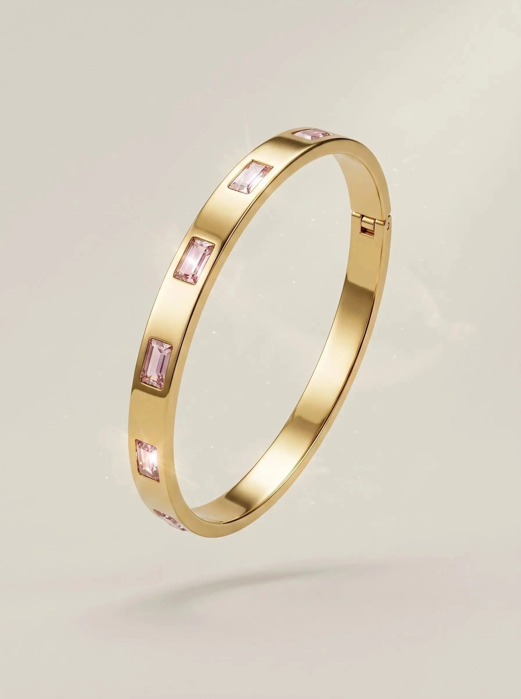 Gold bangle set with pink baguette cut zircon stones