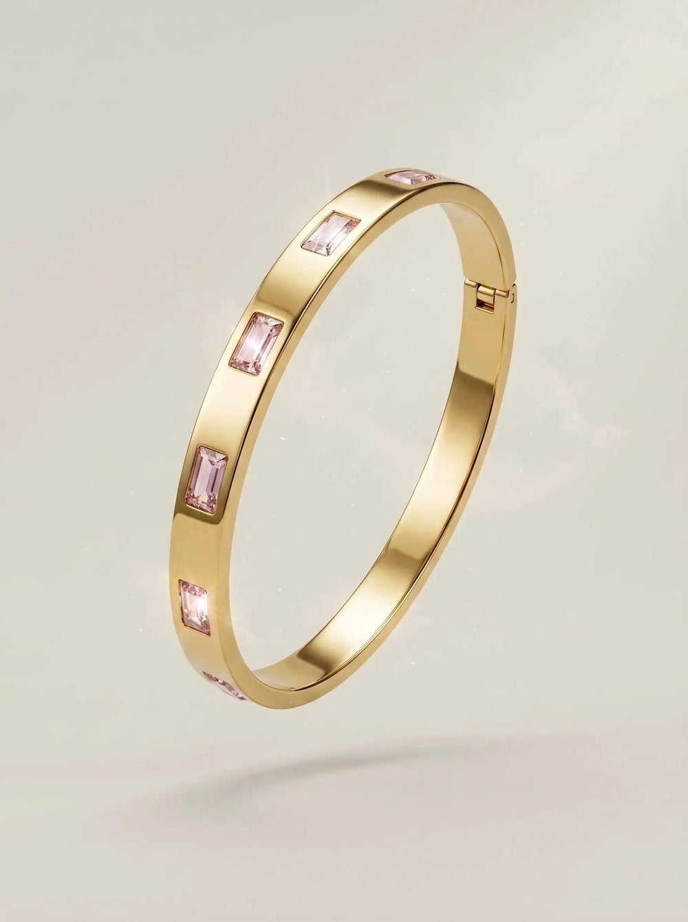 Gold bangle set with pink baguette cut zircon stones